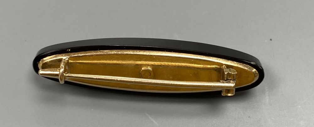 An early 20th century Russian 56 zolotnik yellow metal, black onyx and diamond set oval brooch, 43mm, gross 7.5 grams.